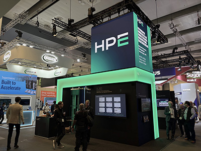 HPE exhibition booth with digital displays and attendees at a technology trade fair.